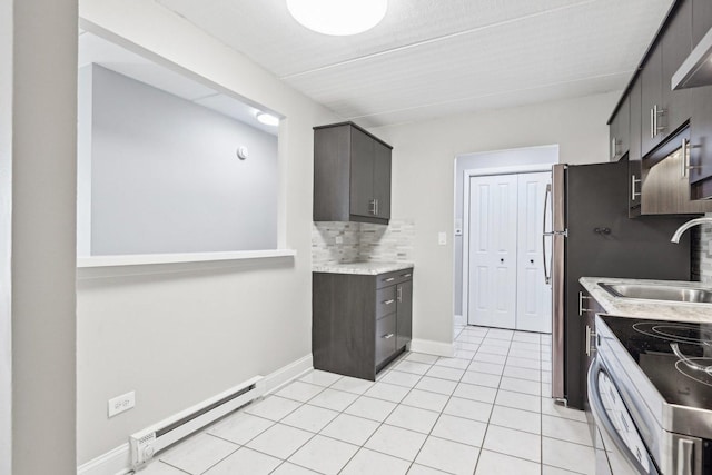 kitchen with backsplash, sink, a baseboard radiator, stainless steel range with electric cooktop, and light tile patterned flooring