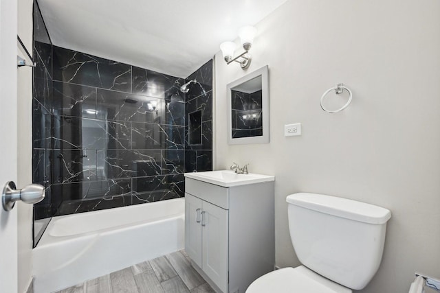 full bathroom with vanity, toilet, and tiled shower / bath