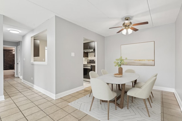 tiled dining area with ceiling fan