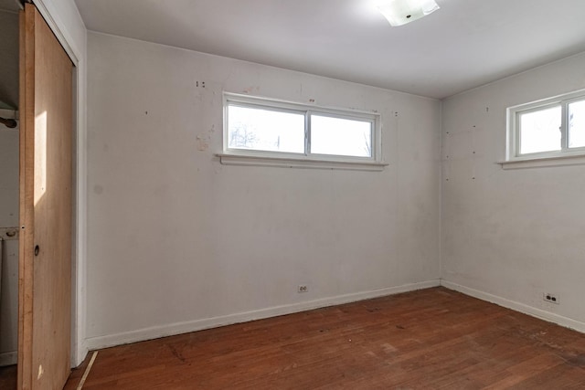 unfurnished room with dark hardwood / wood-style flooring