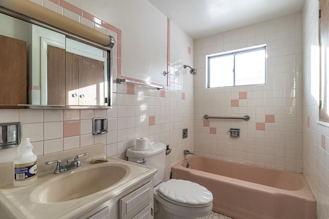 full bathroom featuring vanity, toilet, backsplash, and tiled shower / bath combo