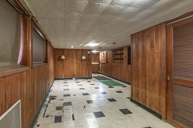 hallway featuring wooden walls