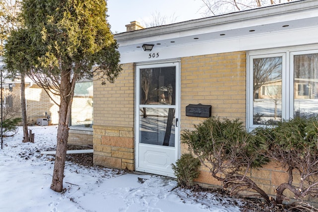 view of snow covered property entrance