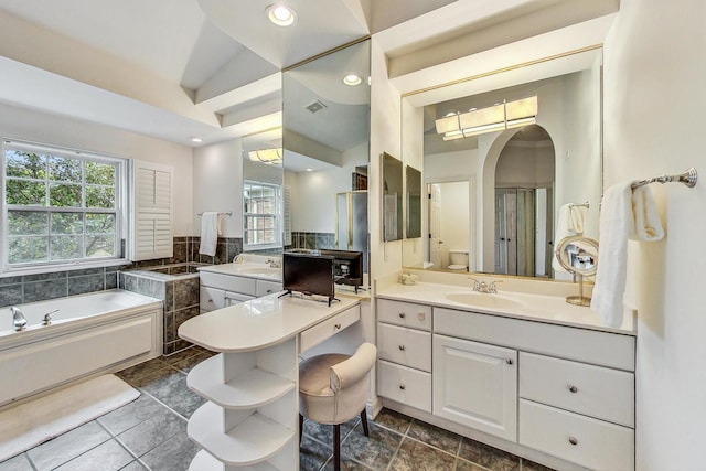 full bathroom featuring toilet, vaulted ceiling, tile patterned flooring, separate shower and tub, and vanity