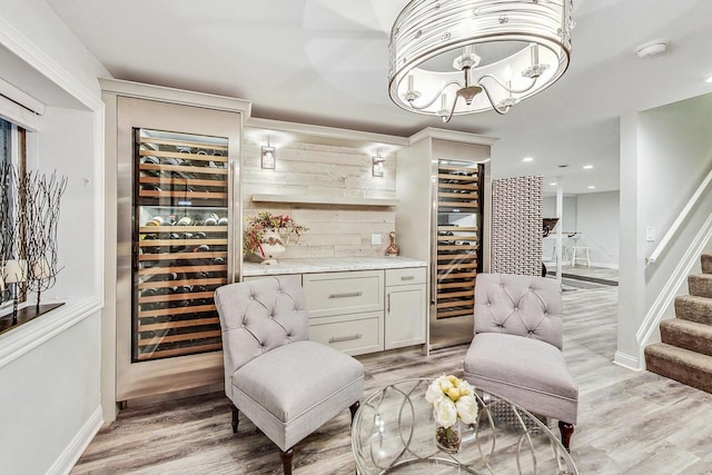 interior space featuring beverage cooler and light hardwood / wood-style floors