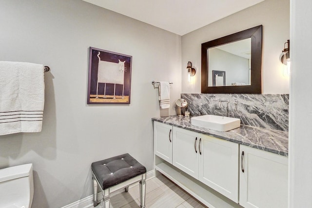 bathroom featuring tile patterned floors, vanity, and toilet