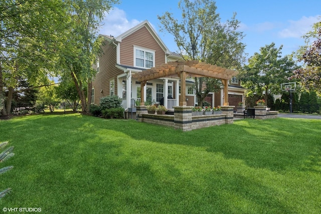 rear view of house featuring a pergola, a yard, and a garage