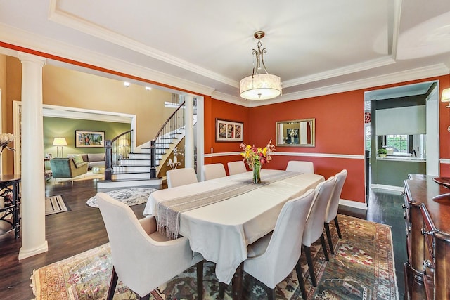 dining area with ornamental molding, a tray ceiling, and dark hardwood / wood-style flooring