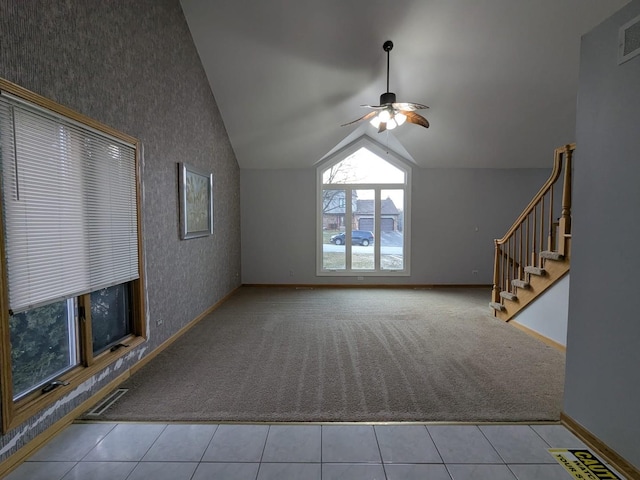 unfurnished living room with light tile patterned floors, ceiling fan, and lofted ceiling