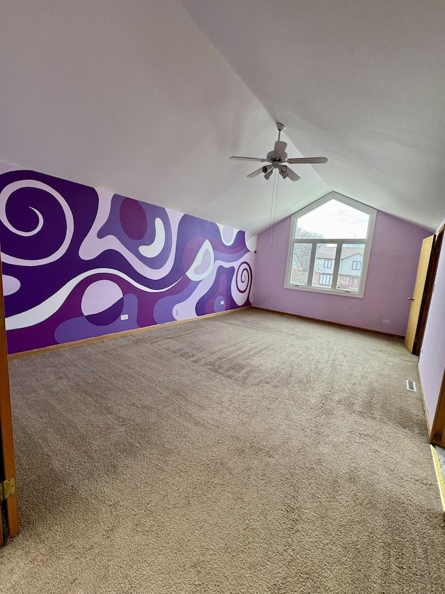 additional living space featuring carpet flooring, ceiling fan, and vaulted ceiling