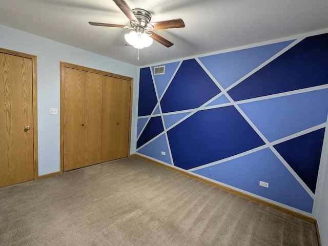 unfurnished bedroom featuring carpet flooring and ceiling fan