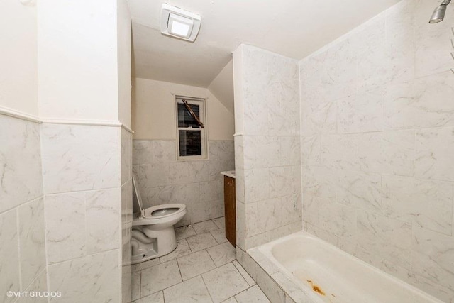 bathroom with vanity, toilet, tile walls, and lofted ceiling