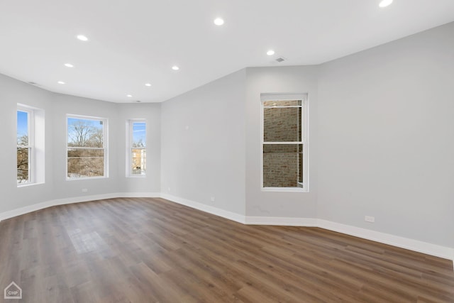 empty room with dark hardwood / wood-style floors