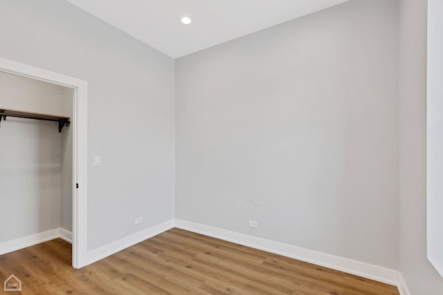 unfurnished bedroom featuring wood-type flooring and a closet