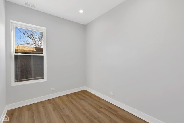 spare room with hardwood / wood-style floors