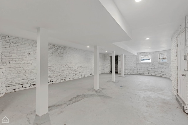 basement with brick wall