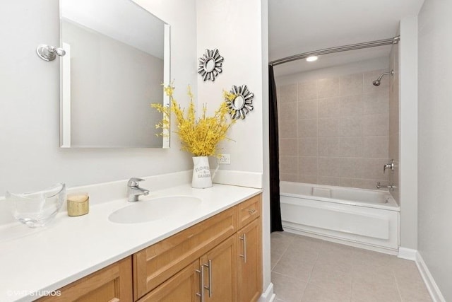 bathroom featuring tile patterned flooring, vanity, and tiled shower / bath combo