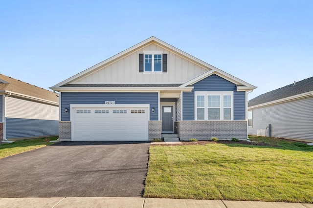 view of front of home with a front yard and a garage