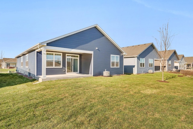 rear view of property with a yard