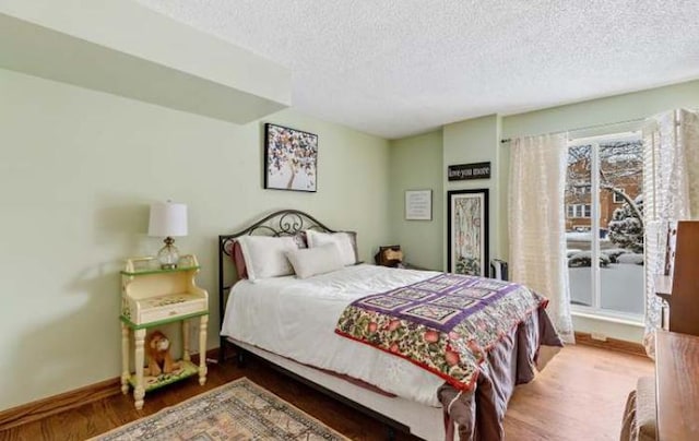 bedroom featuring a textured ceiling and hardwood / wood-style flooring