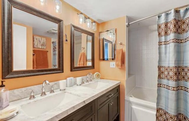 bathroom featuring vanity and shower / bath combo with shower curtain