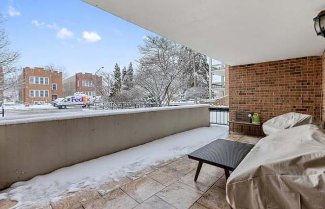 view of snow covered back of property