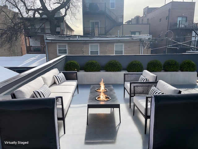 balcony featuring a patio and an outdoor living space with a fire pit