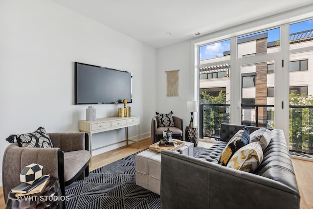 living room with plenty of natural light and hardwood / wood-style floors