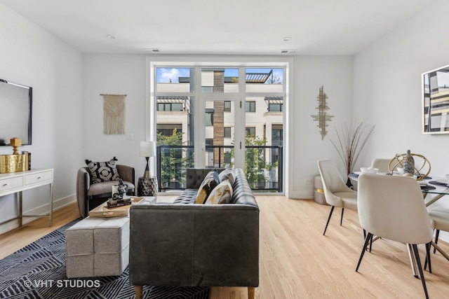 living room featuring french doors and light hardwood / wood-style floors