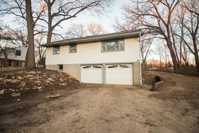 property exterior at dusk featuring a garage