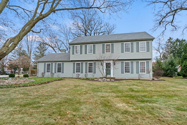 colonial-style house with a front lawn