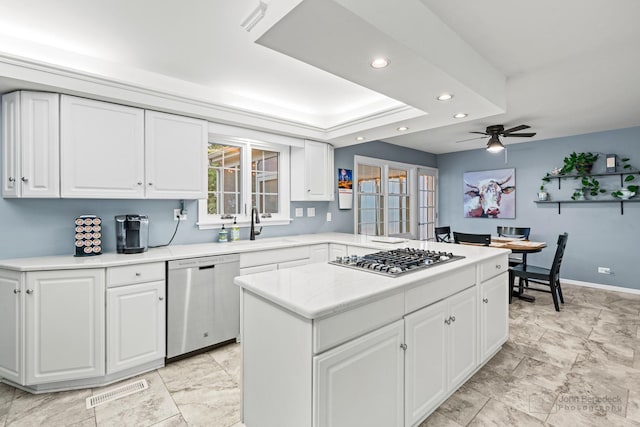 kitchen with ceiling fan, sink, white cabinets, and stainless steel appliances