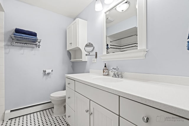 bathroom with vanity, toilet, and baseboard heating