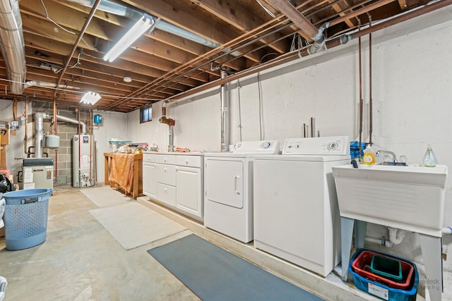 basement featuring gas water heater and washing machine and clothes dryer