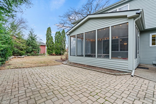 view of patio with a sunroom