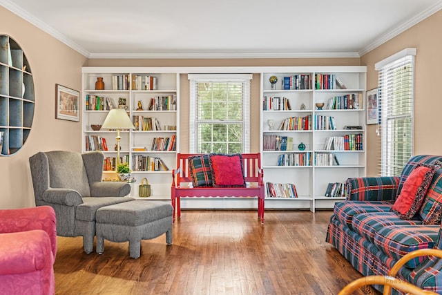 sitting room with hardwood / wood-style flooring and ornamental molding