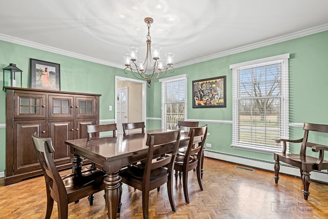 dining area featuring light parquet flooring, a healthy amount of sunlight, crown molding, and an inviting chandelier