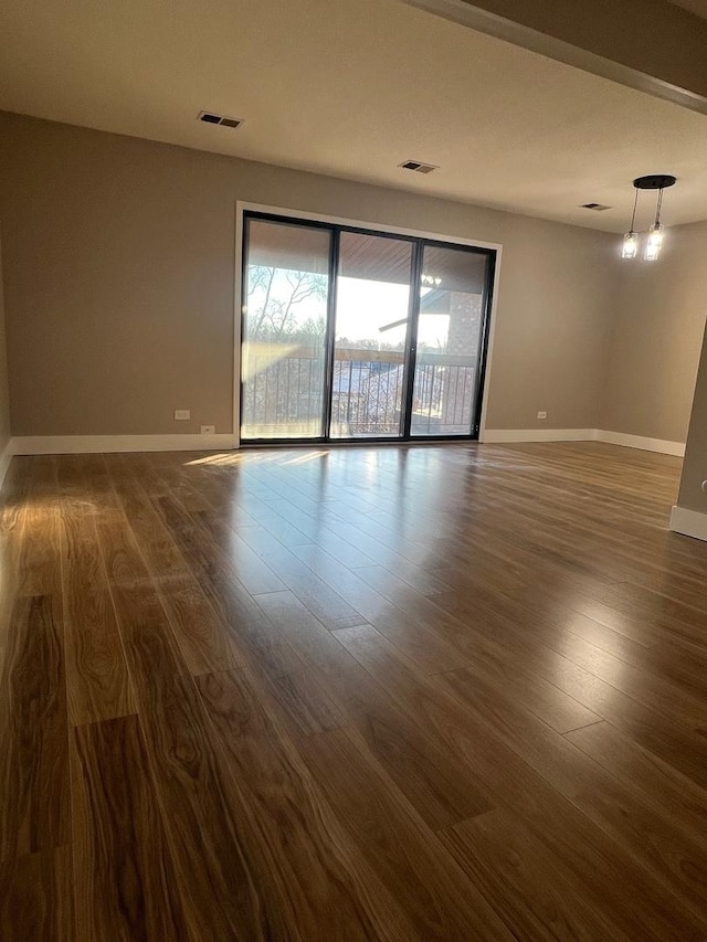 empty room featuring dark wood-type flooring