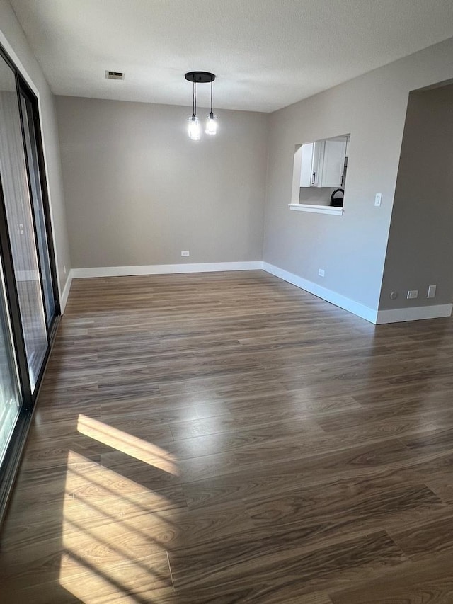 empty room featuring dark wood-type flooring