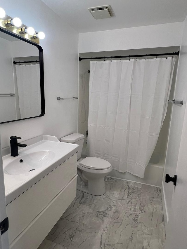 full bathroom featuring vanity, shower / bath combo, and toilet