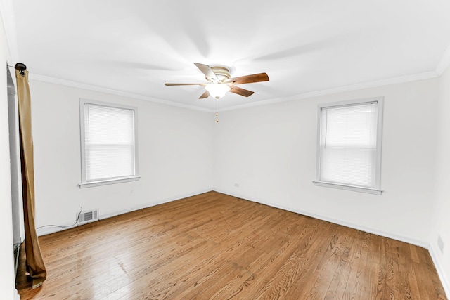 unfurnished room featuring light hardwood / wood-style floors, plenty of natural light, and ornamental molding