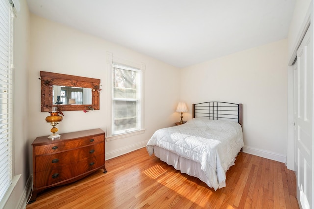 bedroom featuring a closet and light hardwood / wood-style flooring