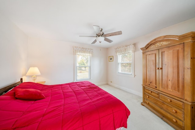 bedroom featuring light carpet and ceiling fan