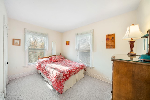 carpeted bedroom with multiple windows