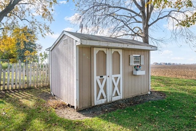 view of outdoor structure featuring a yard and a rural view