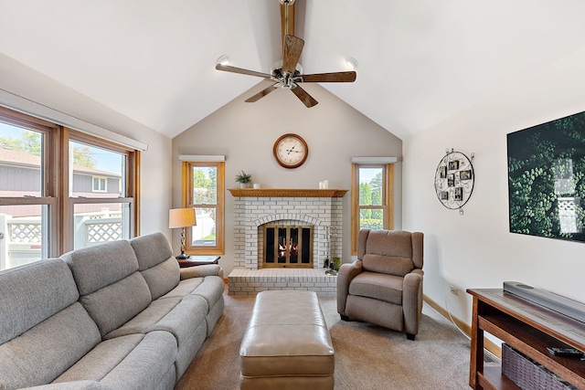 living room featuring vaulted ceiling, ceiling fan, a fireplace, and plenty of natural light