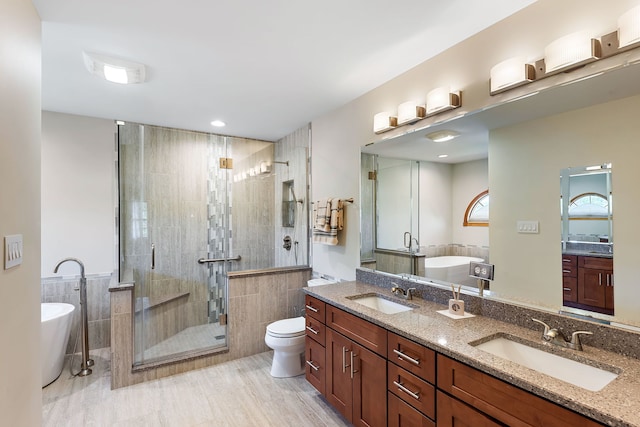 full bathroom featuring toilet, tile walls, separate shower and tub, and vanity