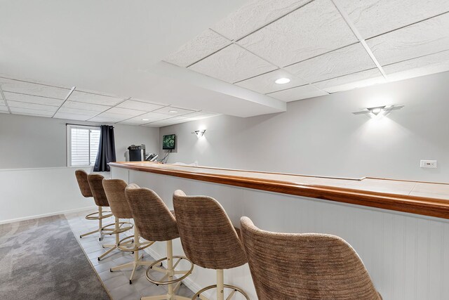 bar featuring a drop ceiling