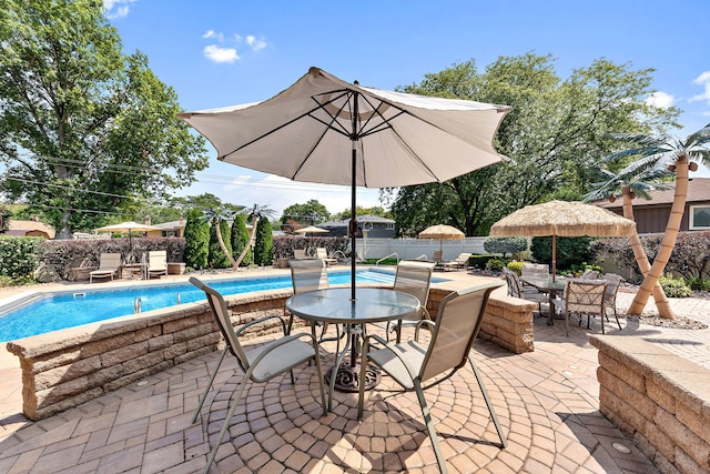 view of patio / terrace with a fenced in pool