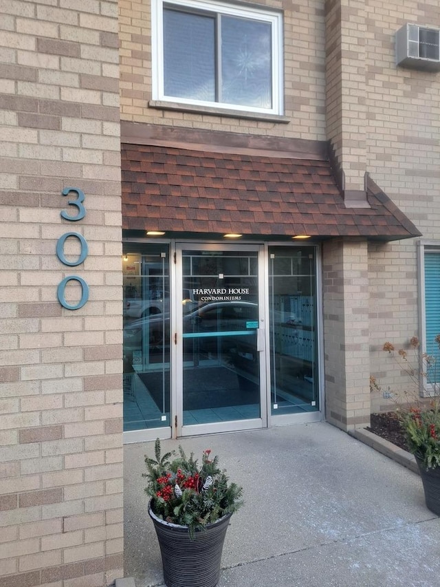 property entrance featuring a wall unit AC